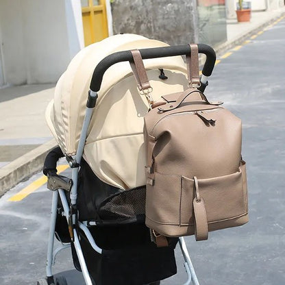 Sac a langer beige attaché à une poussette